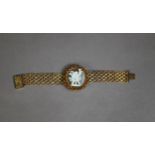 GILT FILIGREE COSTUME BRACELET, with centre oval cameo