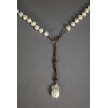 LONG, SINGLE STRAND NECKLACE OF LARGE UNIFORM CULTURED PEARLS, terminating in a fine chain and a