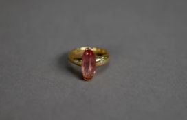 18ct GOLD RING, cross set with a narrow marquise shaped pink stone and a tiny diamond to each