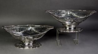 PAIR OF GEORGE III CRESTED AND PIERCED SILVER PEDESTAL FRUIT BASKETS, PROBABLY BY NAPHTHALI HART,