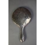 SILVER BACKED LADY?S HAND MIRROR, floral engraved and with scroll embossed border and circular,