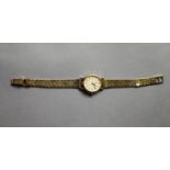 LADY'S OMEGA 9ct GOLD WRISTWATCH, with mechanical movement, the oval dial with batons, the winding
