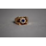 9ct GOLD BROAD SHANKED RING with heavy V shaped shoulders, set with cluster of blue stones and
