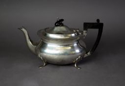 GEORGE V SILVER TEAPOT, of rounded oblong form with black angular scroll handle and knop and pad