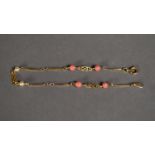 18k GOLD BRACELET, the links punctuated with four coral beads and two seed pearls, 1.8 gms gross