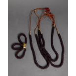 THREE ORIENTAL GARNET BEAD NECKLACES and a garnet bead triple strand BRACELET
