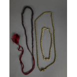 TWO SIMILAR GILT METAL BELCHER CHAIN NECKLACES with cylindrical clasps applied with flowers, one set