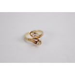 14ct GOLD CROSSOVER RING having double loop pattern top set with two round brilliant cut diamonds,