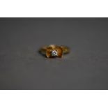 18ct GOLD RING, the bow shape having a round brilliant cut solitaire diamond in a high claw setting,