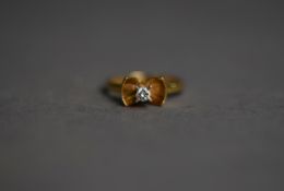 18ct GOLD RING, the bow shape having a round brilliant cut solitaire diamond in a high claw setting,