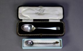 GEORGE V SILVER CASED CHILD?S SPOON, Sheffield 1925, together with a FOREIGN SILVER COLOURE METAL (