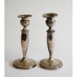 GEORGE V, PAIR OF WEIGHTED AND ENGRAVED SILVER TABLE CANDLESTICKS, with urn shaped sconces with