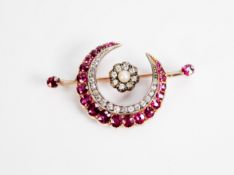 LATE VICTORIAN/EDWARDIAN GOLD (unmarked) CRESCENT SHAPE BROOCH, set with twenty one graduated rubies