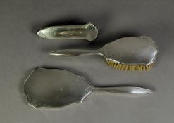 THREE PIECE ENGINE TURNED SILVER BACKED DRESSING TABLE HAND MIRROR AND BRUSH SET, comprising: HAND