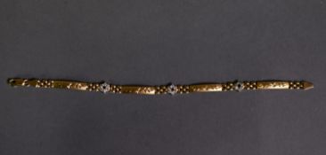 .750 marked GOLD BRACELET, the links punctuated with three clusters each of a tiny ruby (one absent)