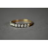 GOLD AND DIAMOND HALF ETERNITY RING set with ten round brilliant cut diamonds, approximately 1/2