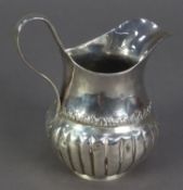 UNMARKED ANTIQUE SILVER MILK JUG, of part fluted and footed baluster form with high scroll handle