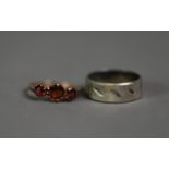 9ct GOLD RING claw set with three garnets, Birmingham 1915, ring size N/O, 1.3gms and a white