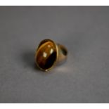 9ct GOLD DRESS RING, set with a large oval tiger?s eye, ring size J, 9.6gms