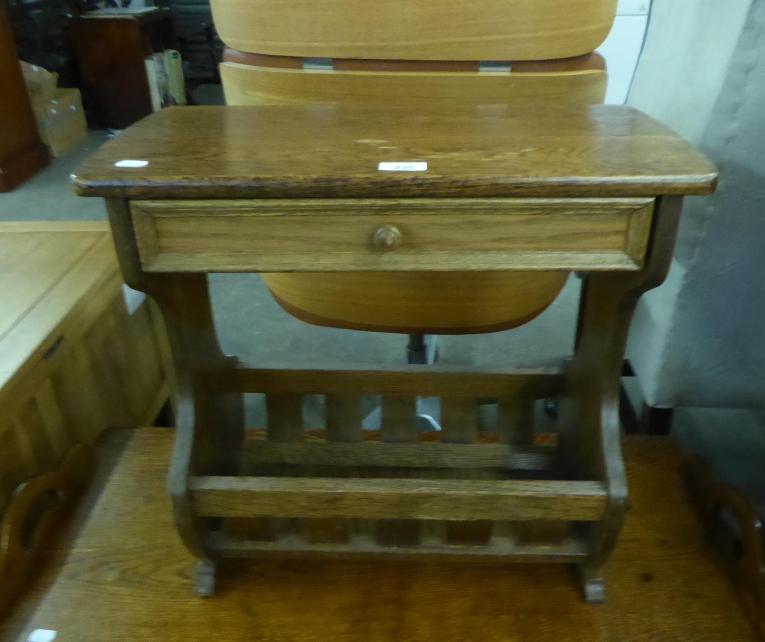 AN OAK OBLONG COFFEE TABLE, WITH DRAWER AND PERIODICAL RACK BELOW