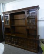 A LARGE OAK DISPLAY SIDE UNIT WITH OPEN SHELVES, GLAZED DOORS, THE ADVANCED BASE WITH FOUR