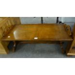 AN OAK OBLONG REFECTORY STYLE COFFEE TABLE, WITH HANDLES TO EACH SIDE