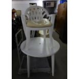 A WHITE PLASTIC CIRCULAR TABLE AND TUB ARMCHAIR