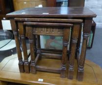 A NEST OF THREE JACOBEAN STYLE OAK OBLONG COFFEE TABLES, ON BALUSTER LEGS WITH PLAIN STRETCHERS