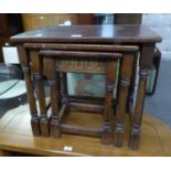 A NEST OF THREE JACOBEAN STYLE OAK OBLONG COFFEE TABLES, ON BALUSTER LEGS WITH PLAIN STRETCHERS