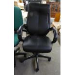 AN EXECUTIVES REVOLVING OFFICE ARMCHAIR, IN BLACK HIDE