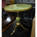 A GILT BRASS AND SIMULATED ONYX CIRCULAR TRIPOD TABLE