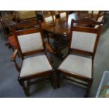 A SET OF SIX JACOBEAN STYLE CARVED OAK DINING CHAIRS WITH UPHOLSTERED BACK PANELS AND DROP IN