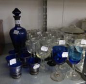 MID TWENTIETH CENTURY BLUE GLASS LIQUEUR DECANTER AND STOPPER AND SIX MATCHING TOTS, WITH PAINTED