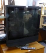 A BANG AND OLUFSON TV ON ROTATING BASE AND A PANASONIC VIDEO PLAYER (2)