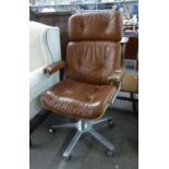 A GIROFLEX 1970's EXECUTIVE REVOLVING OFFICE ARMCHAIR, IN LIGHT TAN HIDE (RIPS TO ARM RESTS AND