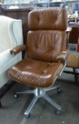 A GIROFLEX 1970's EXECUTIVE REVOLVING OFFICE ARMCHAIR, IN LIGHT TAN HIDE (RIPS TO ARM RESTS AND