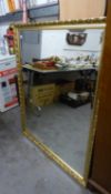 A LARGE OBLONG BEVELLED EDGE WALL MIRROR, IN GILT FRAME