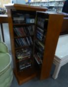 A POLISHED WOOD CD STORAGE CABINET AND A SELECTION OF DVD?s