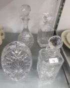 TWO SQUARE CUT GLASS CRYSTAL DECANTERS, A CUT GLASS WINE DECANTER AND A BASKET PATTERN FRUIT BOWL (