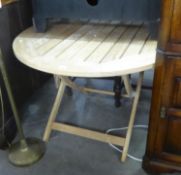 A TEAK CIRCULAR FOLD-FLAT DINING TABLE AND A SIMILAR CIRCULAR COFFEE TABLE (2)