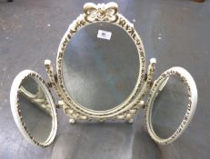 WHITE PAINTED AND MOULDED TRIPTYCH DRESSING TABLE MIRROR, heightened in gilt and with central,