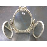 WHITE PAINTED AND MOULDED TRIPTYCH DRESSING TABLE MIRROR, heightened in gilt and with central,