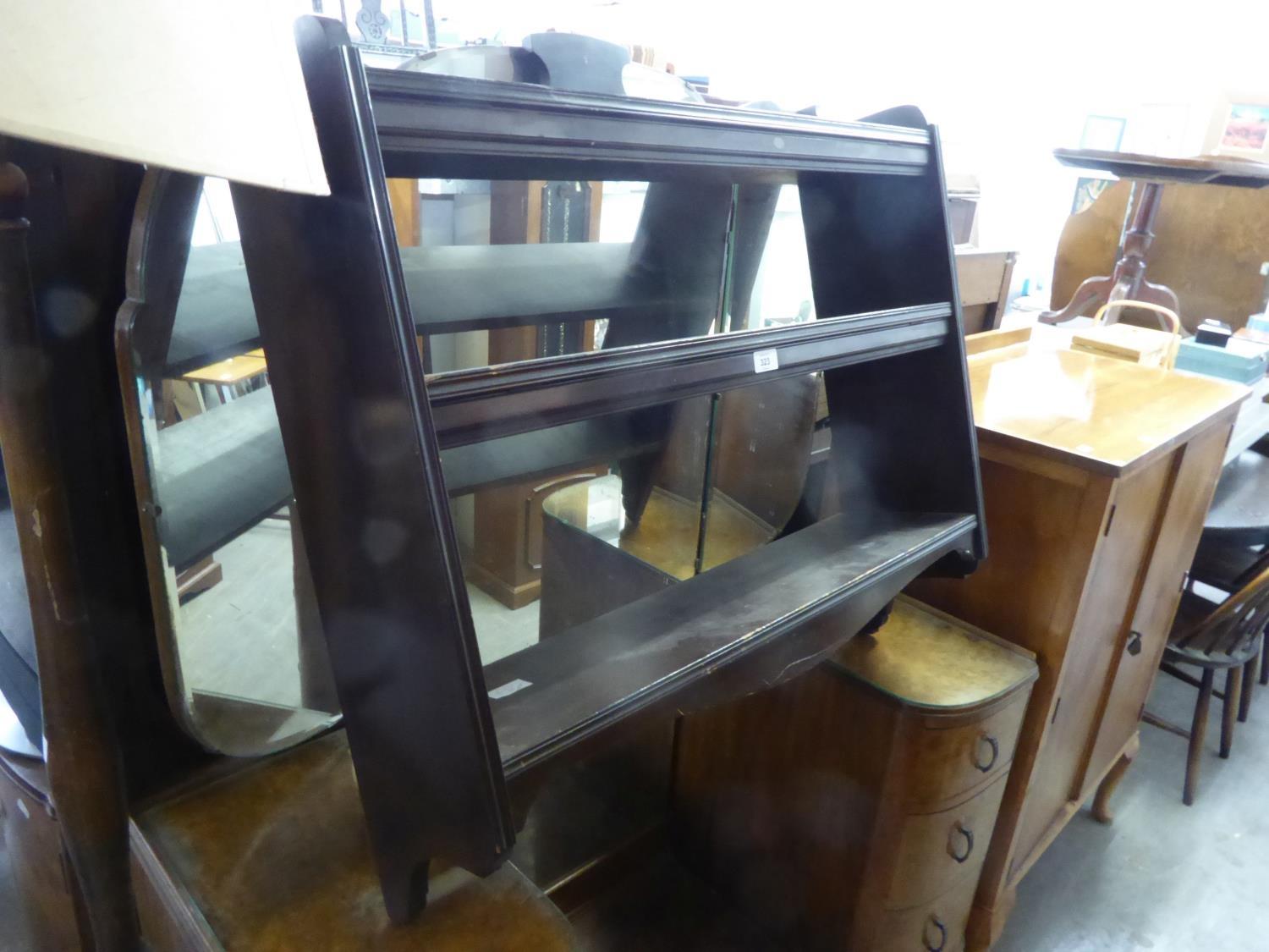 AN EARLY 20TH CENTURY EBONISED MURAL TWO TIER OPEN SHELVES WITH HINGED DUST FLAPS, 2?10? WIDE