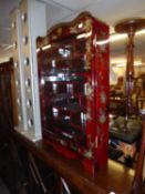 AN ORIENTAL LACQUERED WALL DISPLAY CABINET WITH GLAZED DOOR AND STEPPED SHELVES, MIRRORED BACK, 2?