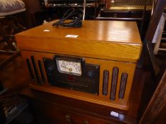 A LIGHT OAK CASED VINTAGE STYLE TABLE TOP RADIO, RECORD TURNTABLE AND CASSETTE TAPE PLAYER