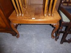 A GOOD QUALITY FIGURED WALNUT OBLONG COFFEE TABLE, WITH CANTED CORNERS, ON FOUR FOLIATE SCROLL