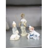 THREE LLADRO PORCELAIN FIGURES - A YOUNG MAN HOLDING A FISHING ROD AND CARRYING A CREEL, ON OVAL