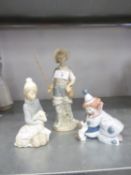 THREE LLADRO PORCELAIN FIGURES - A YOUNG MAN HOLDING A FISHING ROD AND CARRYING A CREEL, ON OVAL