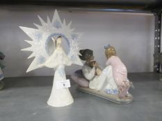 MODERN LLADRO PORCELAIN MODEL OF A YOUNG MOTHER reclining cradling a new born child with an older