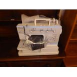 A MODERN SINGER ELECTRIC PORTABLE SEWING MACHINE